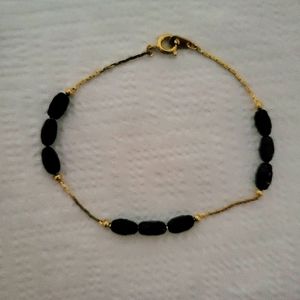 A never worn, OS fits all, gold plated and black beaded Joan Rivers bracelet.